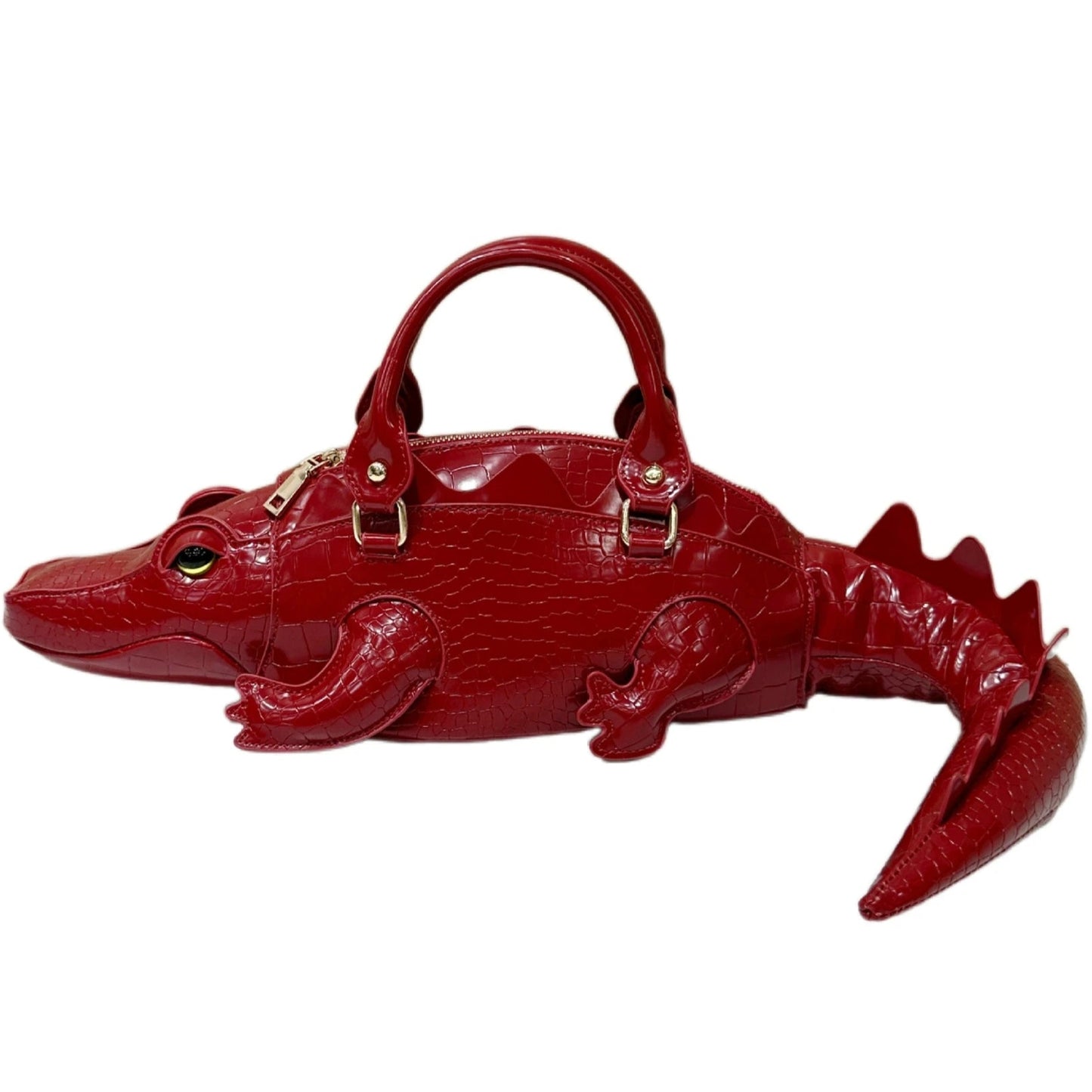 Red alligator-shaped handbag on a white background