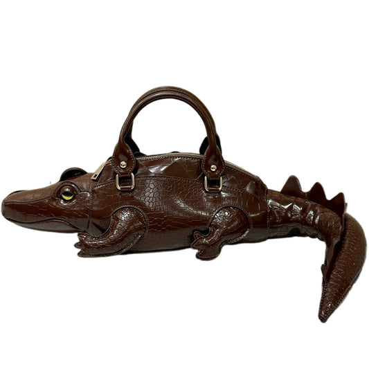 Brown alligator-shaped handbag on a white background