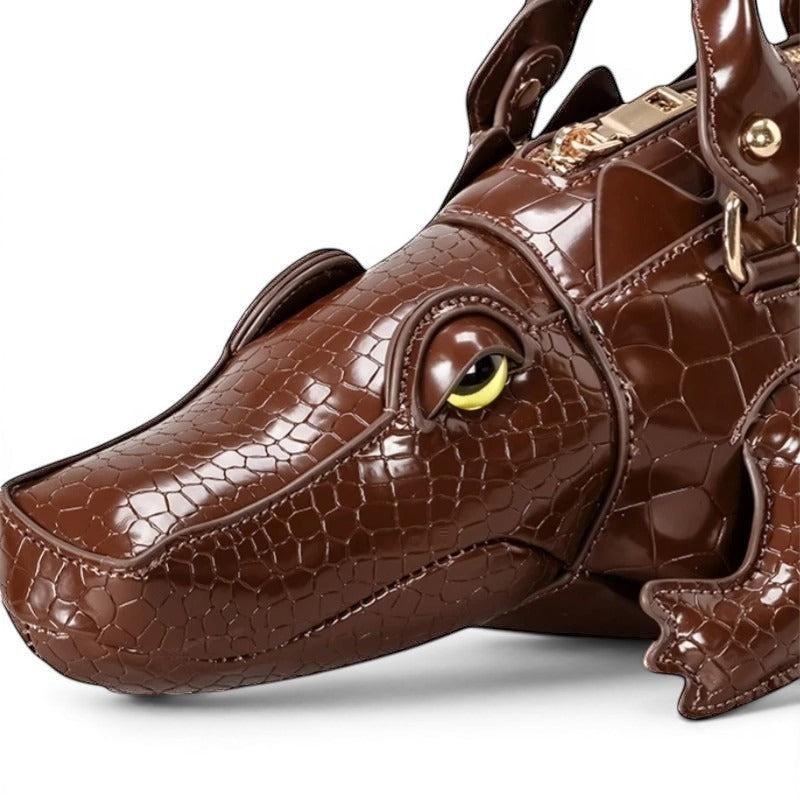 Pordein brown vegan leather alligator shoulder bag with embossed scales and yellow eye detail.