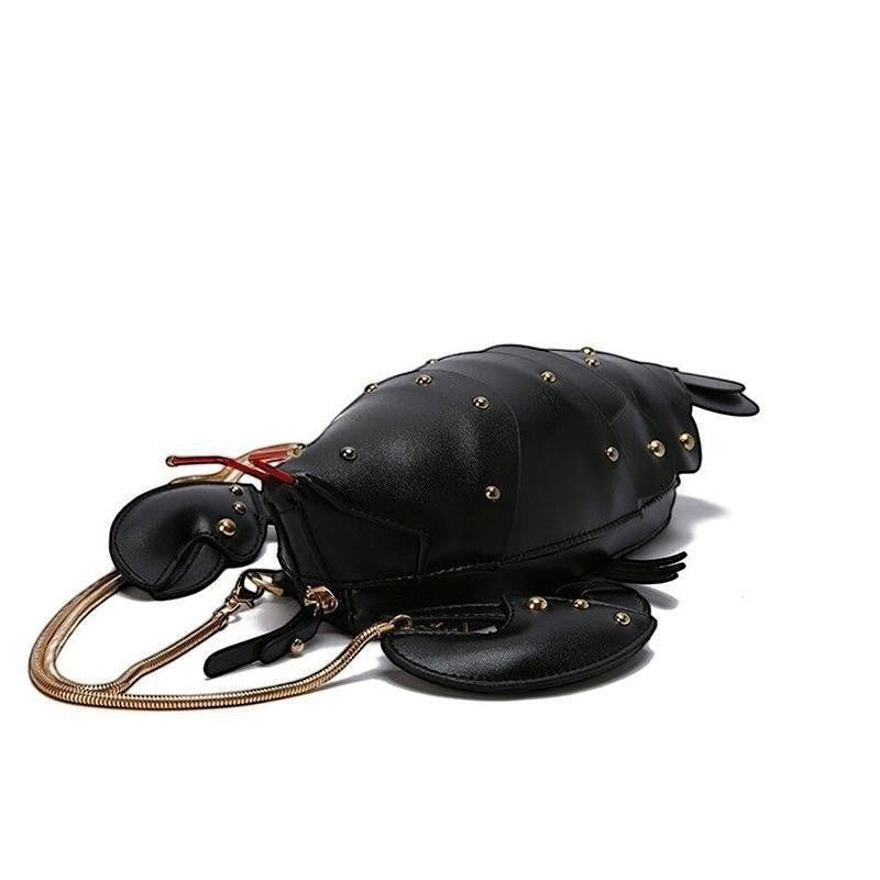 Pordein black vegan leather lobster mini bag with gold stud details and chain strap.