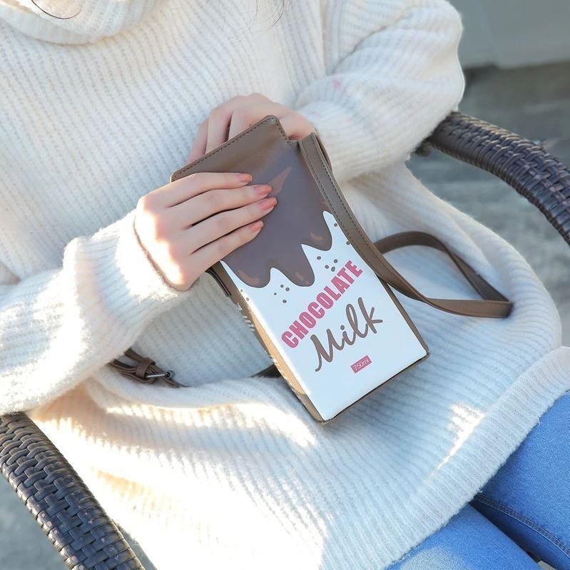 Pordein chocolate milk carton mini bag made of PU leather with a button closure and adjustable strap.