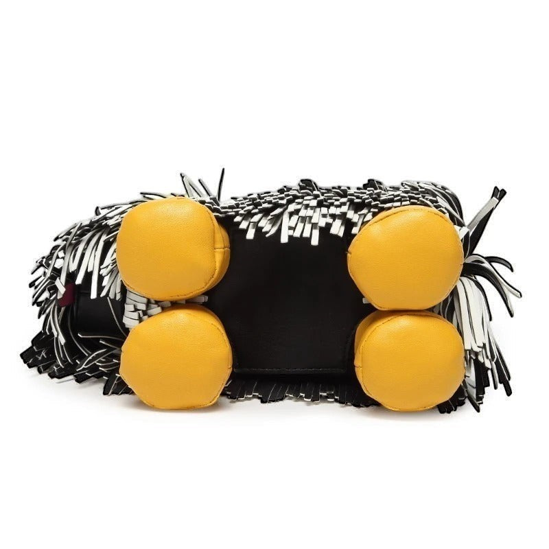 Pordein Cooper Cross Body Bag in black vegan leather with yellow feet and white fringe detail.