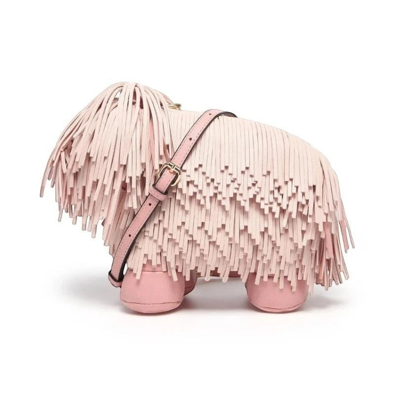 Pordein Cooper Cross Body Bag in light pink vegan leather, shaped like a Highland cow with fringe detailing and gold-tone hardware.