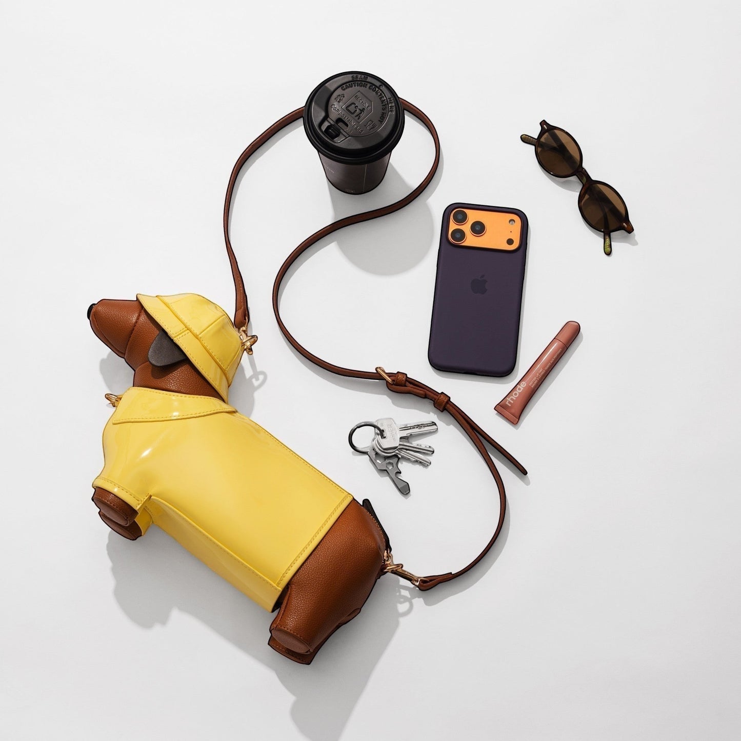 Pordein brown leather dachshund bag with yellow raincoat and hood, crossbody strap