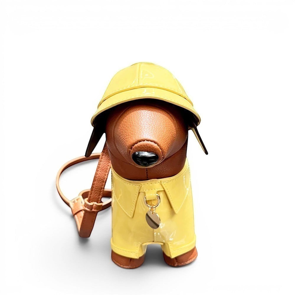 Pordein yellow patent leather dachshund shoulder bag with brown accents and a matching hat.