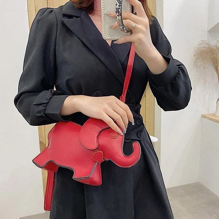 Pordein Elly Mini Bag, a red elephant-shaped crossbody bag made of PU leather. Features adjustable strap.
