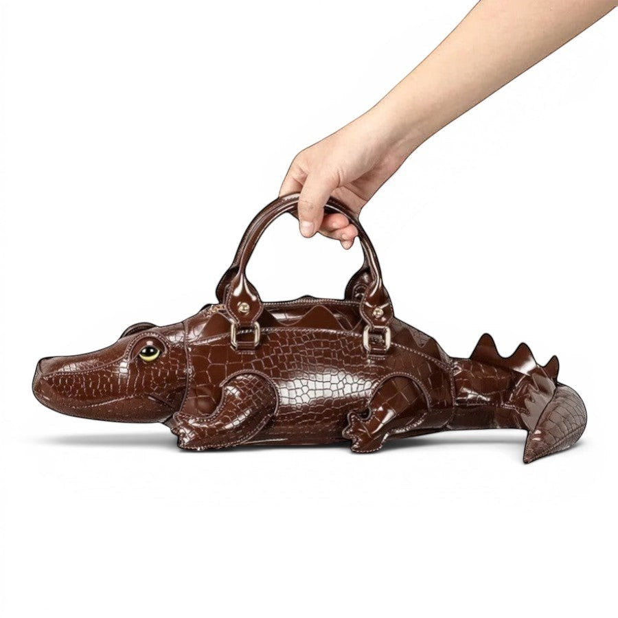 Pordein brown crocodile-embossed vegan leather shoulder bag shaped like a gator with tail detail.