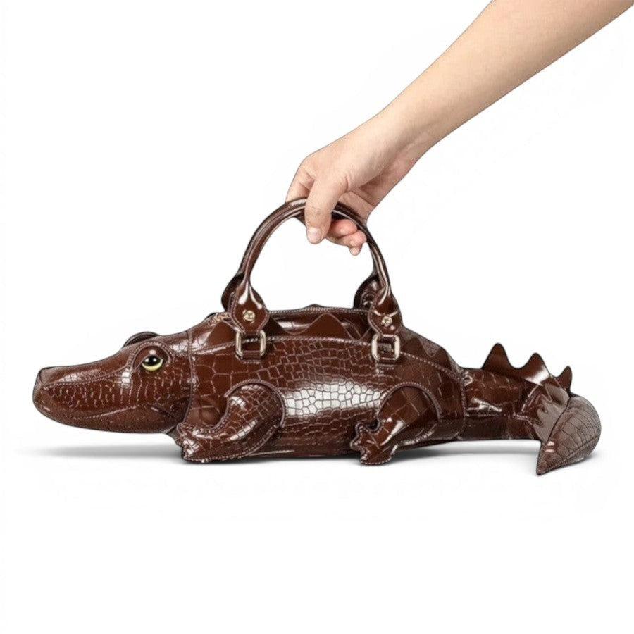 Pordein brown crocodile-embossed vegan leather shoulder bag shaped like a gator with tail detail.