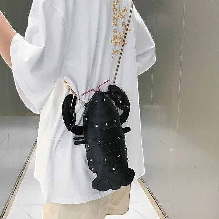 Pordein black PU leather lobster mini bag with silver stud details and a crossbody chain strap.