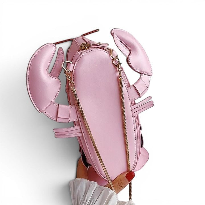 Pordein pink PU leather lobster mini bag with gold chain strap. Playful and unique accessory.