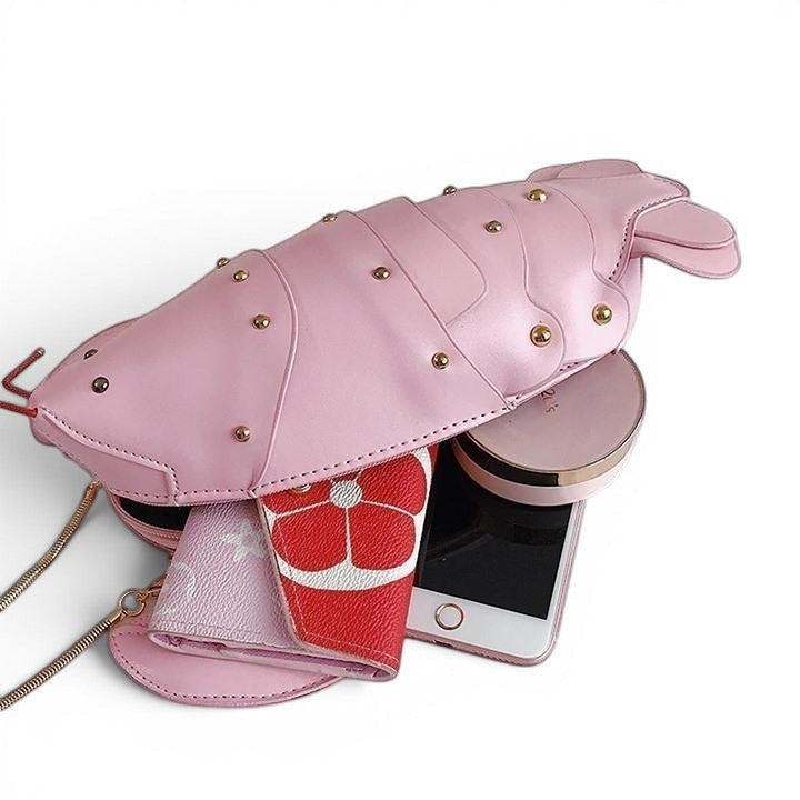 Pordein pink PU leather lobster mini bag with gold stud details, featuring a chain strap and holding a phone and wallet.