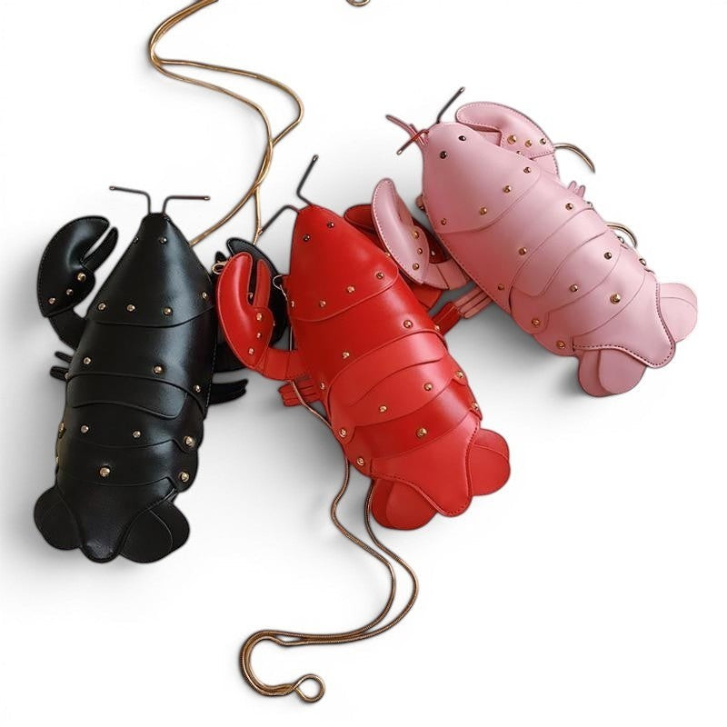 Pordein Lobster Mini Bag in red, black, and pink PU leather. Playful, unique novelty handbag with gold stud details.