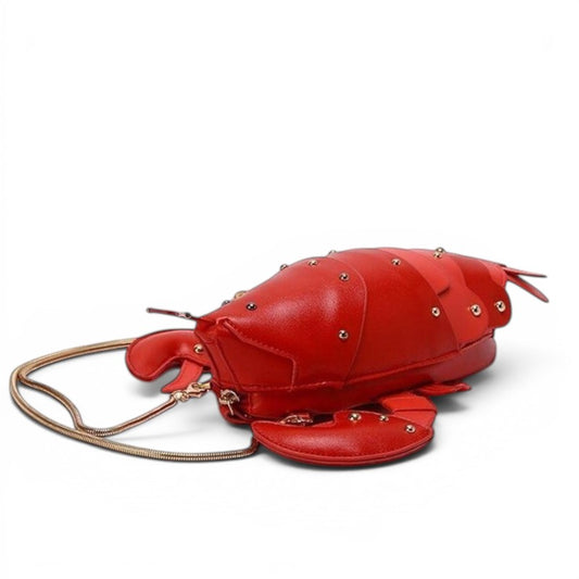 Pordein red PU leather lobster mini bag with gold chain strap and gold stud details.