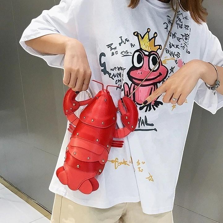 Pordein red vegan leather lobster mini bag with gold stud details. Playful, unique accessory.