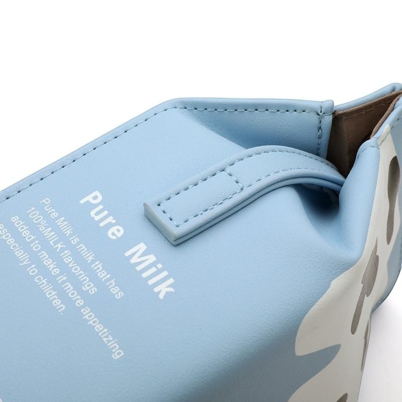 Pordein light blue PU leather mini bag shaped like a milk carton with "Pure Milk" text and adjustable strap.