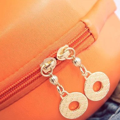 Pordein orange vegan PU leather mini bag with gold zipper details and circular charms.