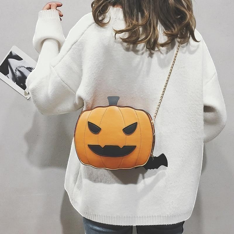 Pordein orange pumpkin handbag with black face details and a bat charm, made of PU leather.