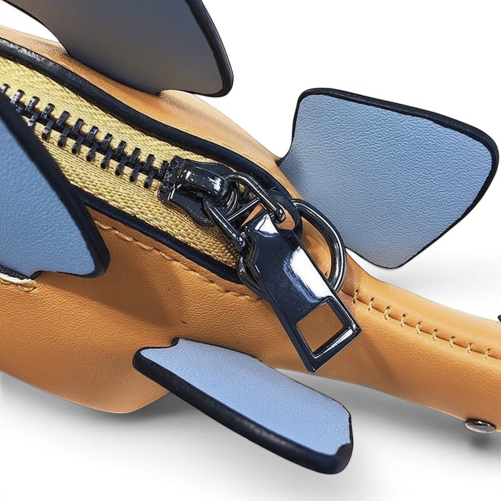 Pordein Stegosaurus Mini Bag in tan vegan leather with blue accent plates and a silver zipper.
