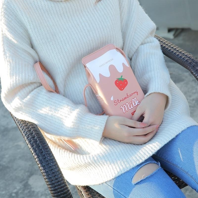 Pordein pink faux leather mini bag shaped like a strawberry milk carton with adjustable strap.
