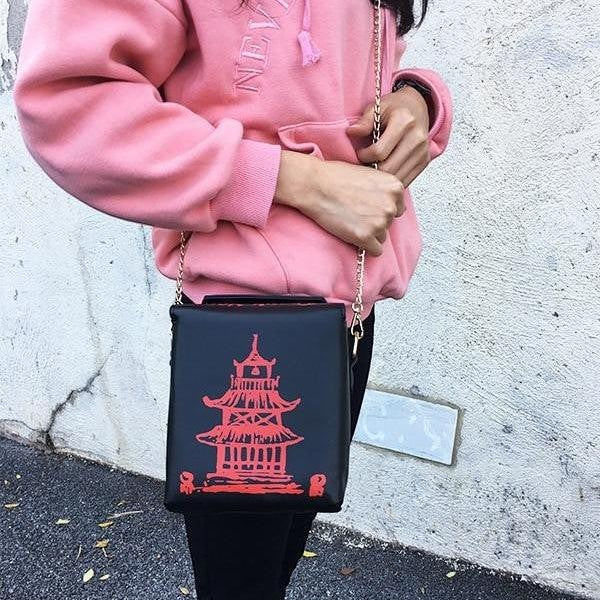 Pordein black mini bag shaped like a Chinese takeaway box with a red pagoda design. Made of PU leather.